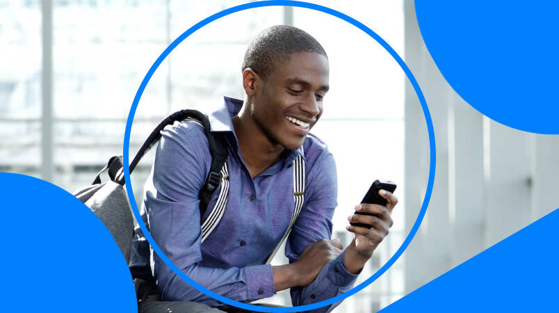 African male chatting on his mobile phone at the airport